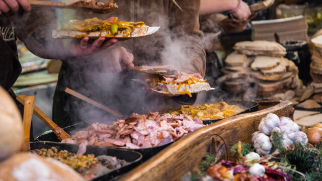Food booth selling traditional Polish street food in Main Square, Kraków at Christmas market.